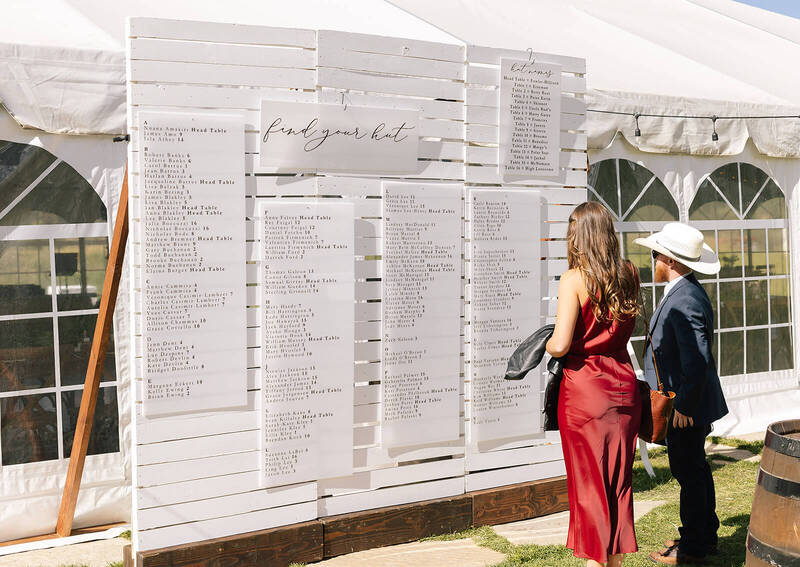 White wood panel seating chart at a Colorado wedding