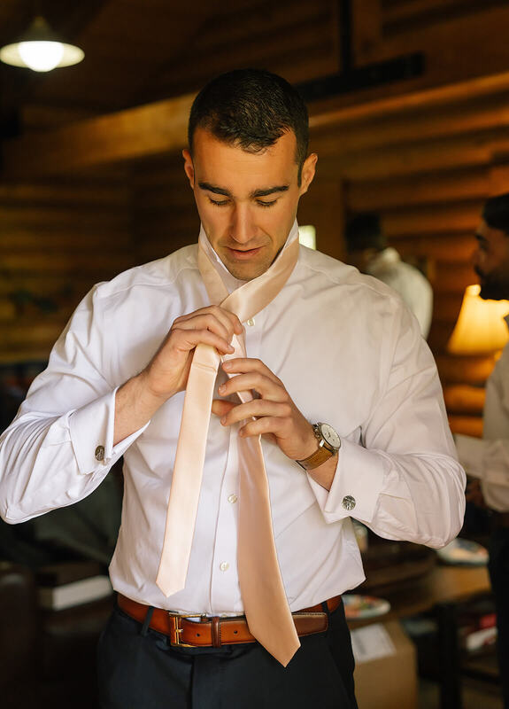 Groom getting ready for his wedding at Camp Hale