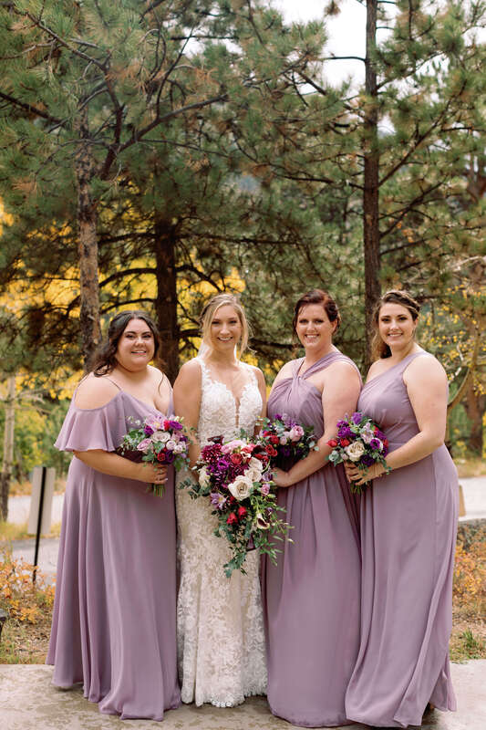 Bridal party portraits with bridesmaids in dusty purple gowns.