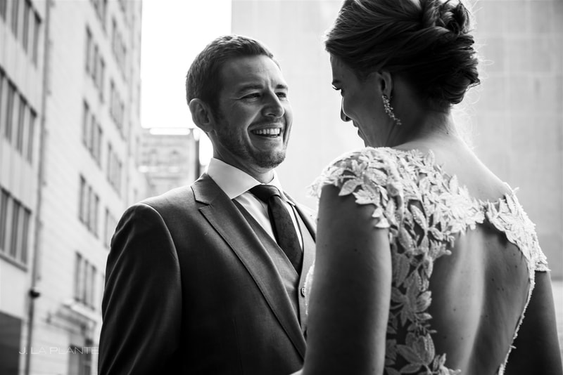 black and white photo of a downtown denver wedding groom's first look at his bride