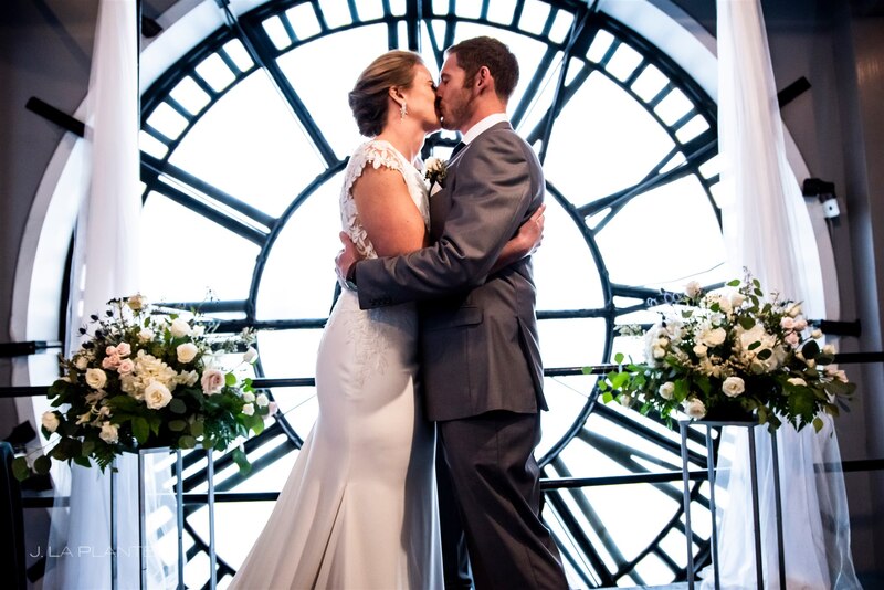 downtown denver clocktower wedding couple first kiss