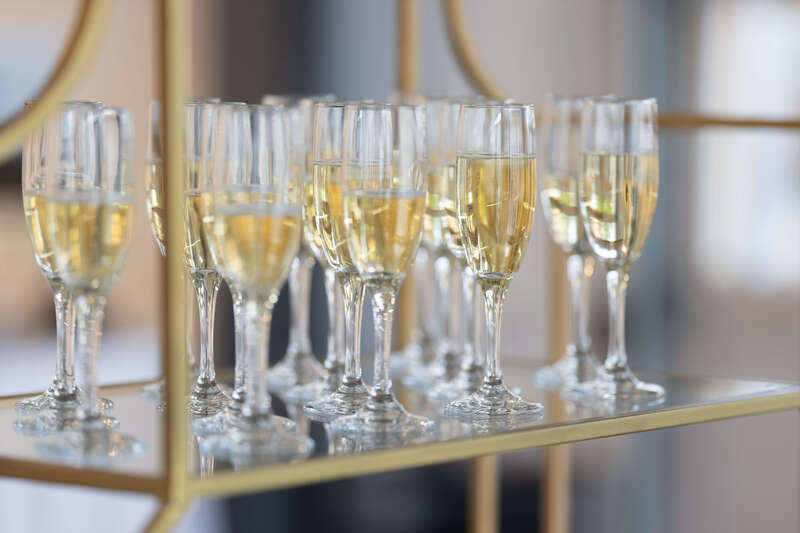 Gold champagne shelf at the entrance to a wedding ceremony