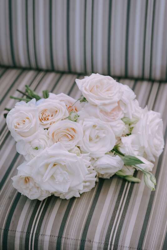 A bridal bouquet filled with white roses by Newberry Brothers