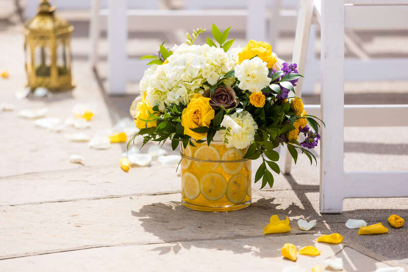 Lemon slice vase with yellow roses and white hydrangeas by Earth Tones Floral