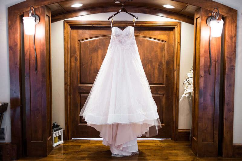 Wedding dress hanging in a doorway at Cielo at Castle Pines