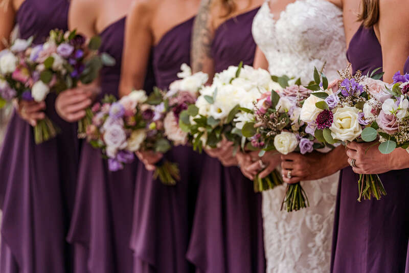 Bridal bouquets with ivory and purple roses by Plum Sage