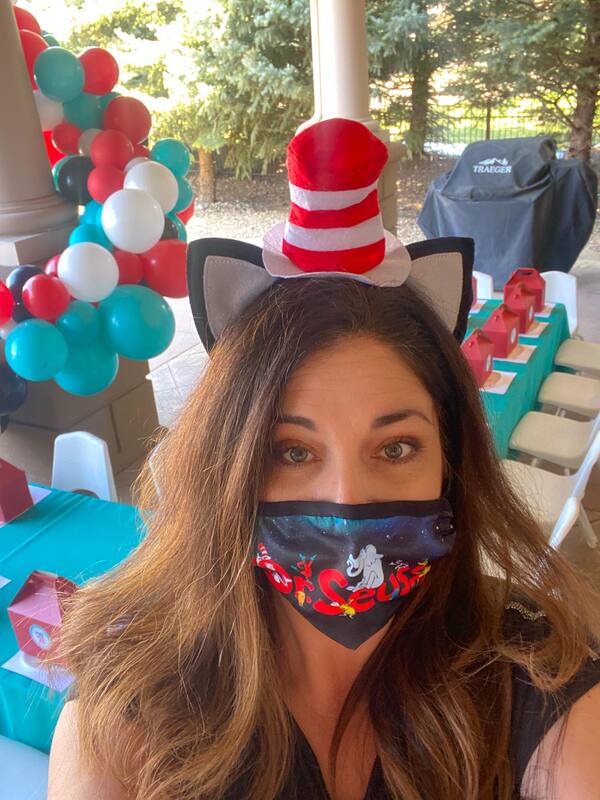 Angie of Sapphire Celebrations in a Cat in the Hat headband and facial covering