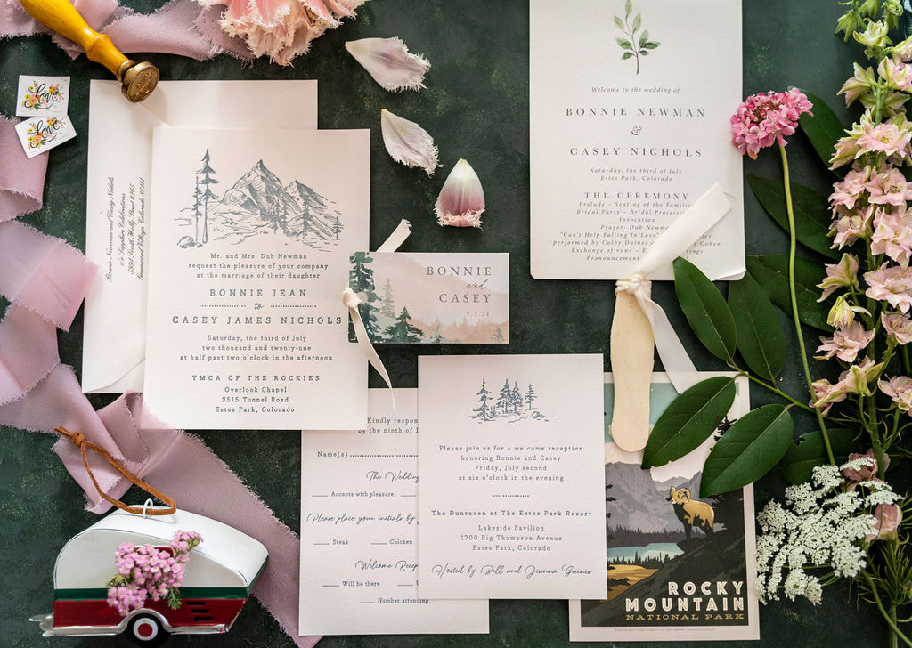Flatlay of an invitation suite for a destination wedding in the Rocky Mountains