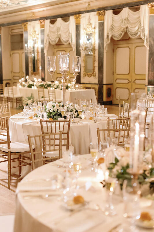 White linens and blush wedding flowers on a table in the Main Ballroom at The Broadmoor