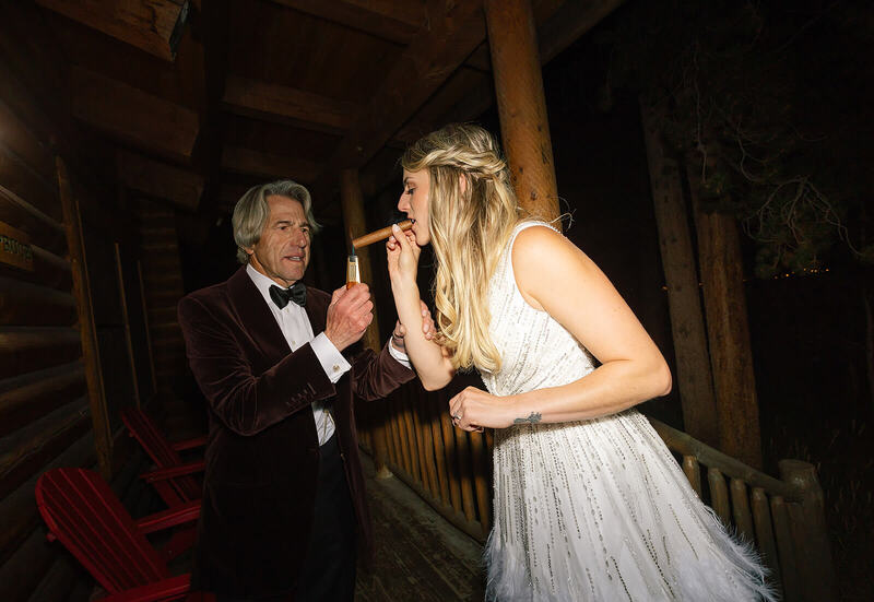 Bride smoking a cigar at her Colorado wedding