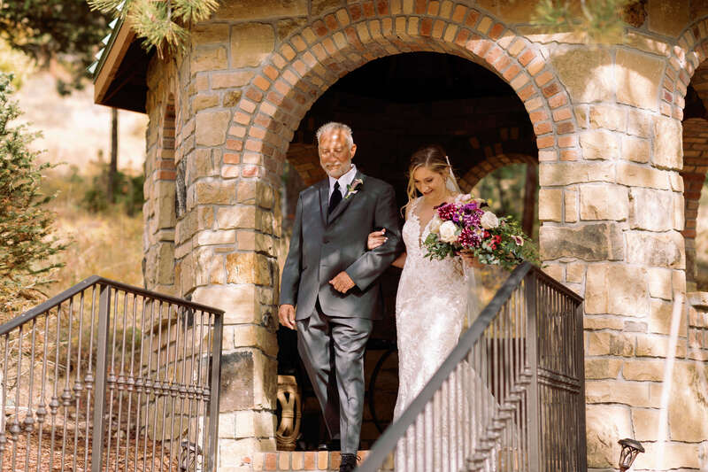 Bride walking down the aisle with her father at Della Terra Mountain Chateau
