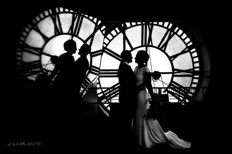 black and white altered photo of the bride and groom in front of the Clocktower clock faces