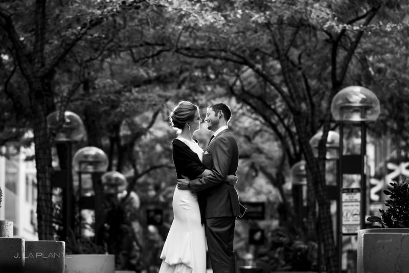 black and white photo of bride and groom along downtown denver street