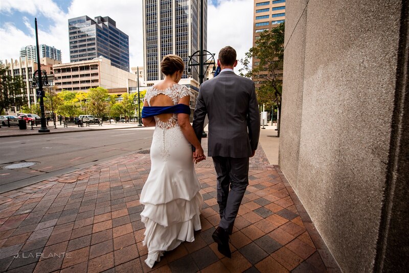 downtown denver wedding couple walking along tiled sidewalk