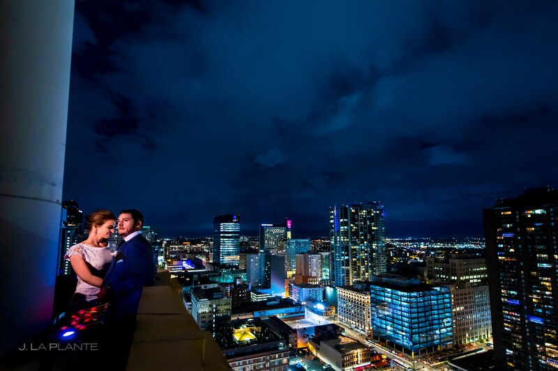downtown denver wedding couple atop the Clocktower downtown with the night lighted city scape on the horizon
