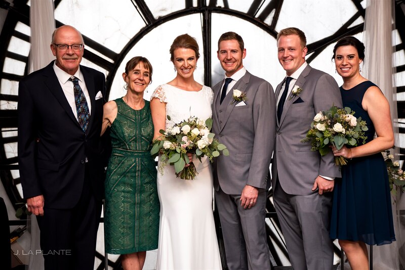 downtown denver wedding couple with their family in front of the clocktower faces