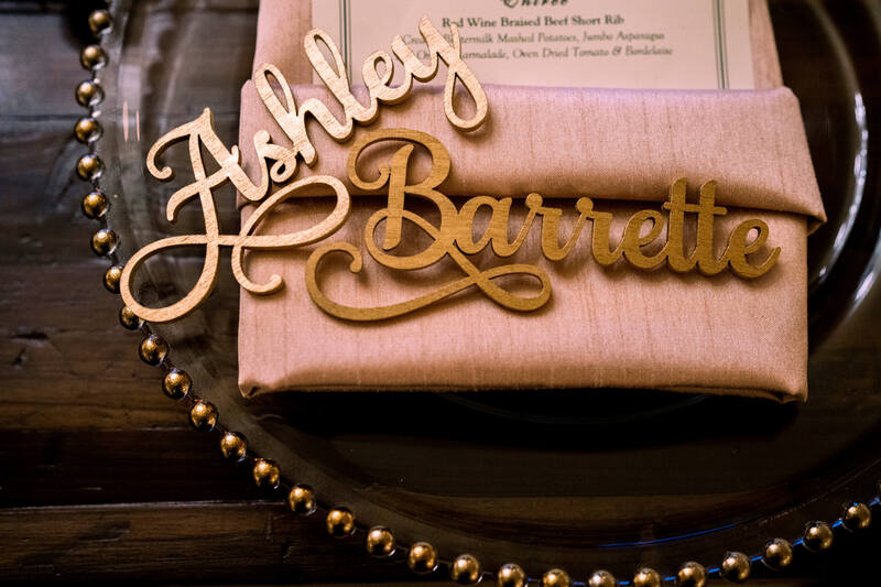 Personalized wooden nameplates at a wedding reception