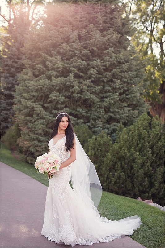 Bride posing on the sidewalk at The Broadmoor