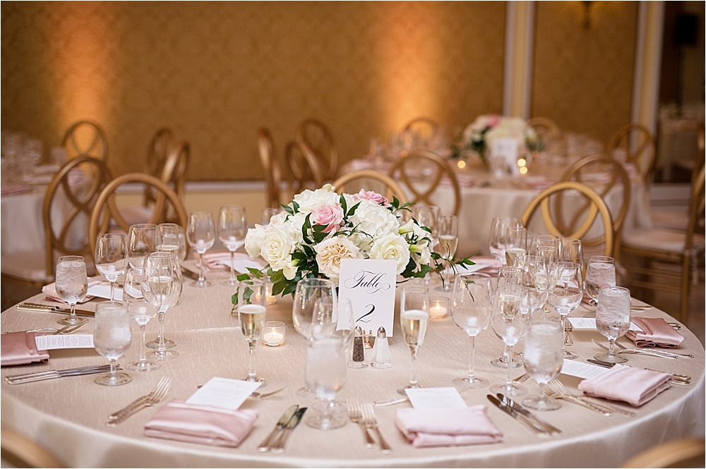 Classic wedding reception with blush table linens and white flowers at The Broadmoor