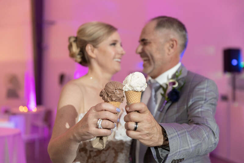 Bride and groom eating ice cream from High Point Creamery at their wedding reception
