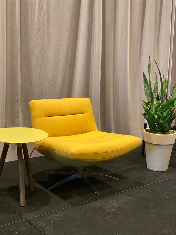 retro, yellow armless chair with potted plant and small, yellow side table