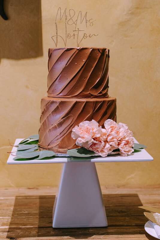 Chocolate wedding cake with pink peonies by Gateaux Bakery