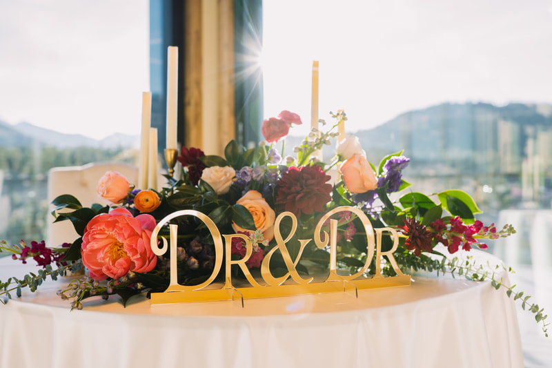 Sweetheart table with a gold "Dr. & Dr." sign at a wedding for two chiropractors