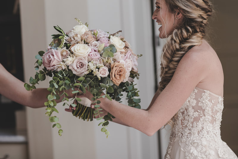 Bridal bouquet with light purple, peach and white roses