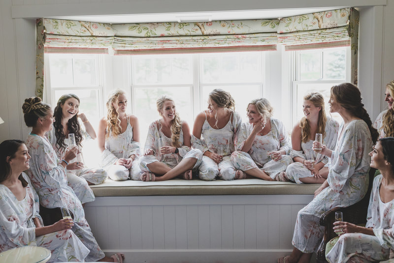 candid photo of the bride with bridesmaids in the bay window