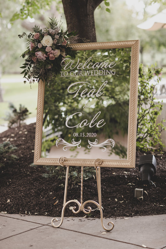Mirror display as the wedding guest welcome sign with cursive writing with wedding couple name and wedding date